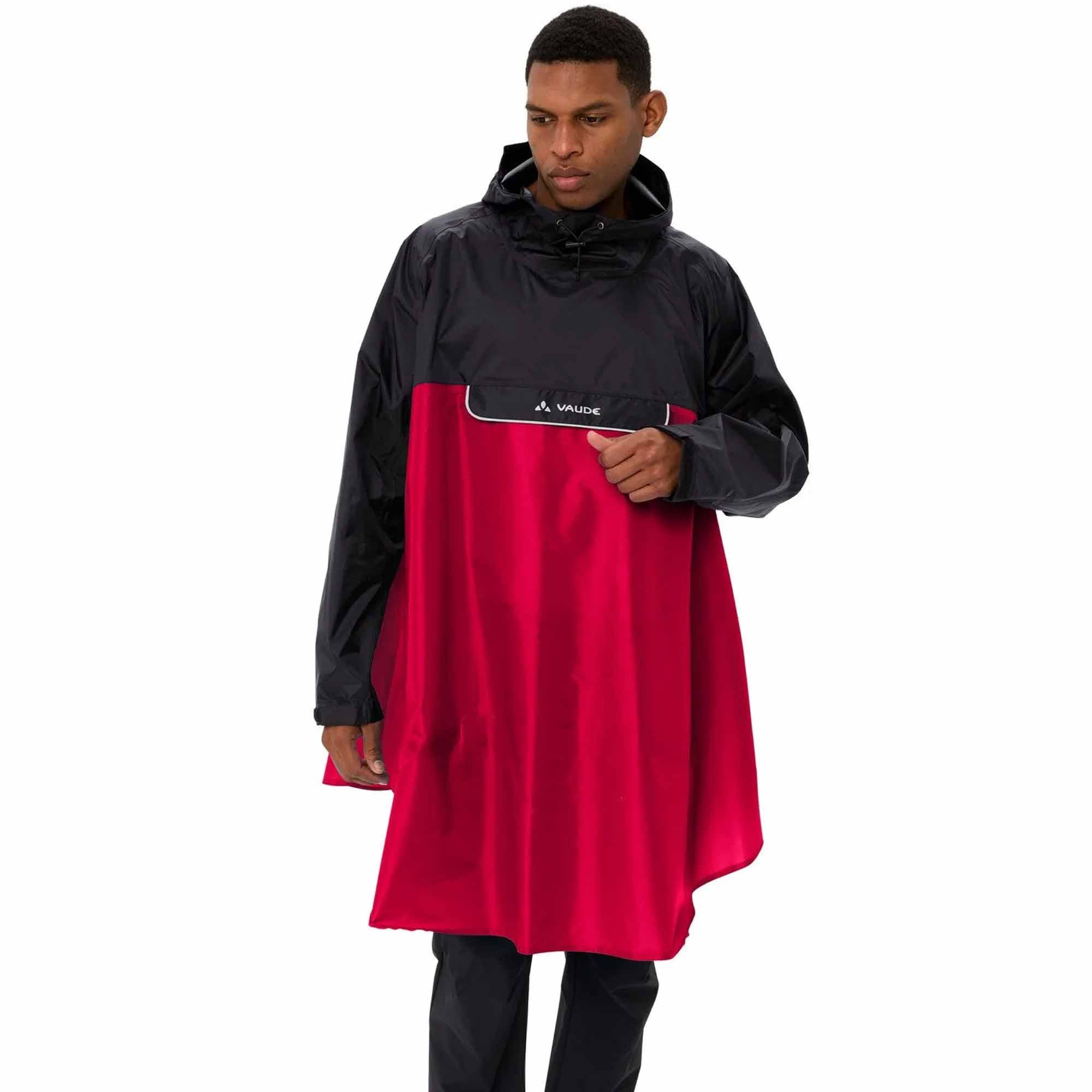 Person wearing a black and red biking rain poncho with Vaude logo on a white background