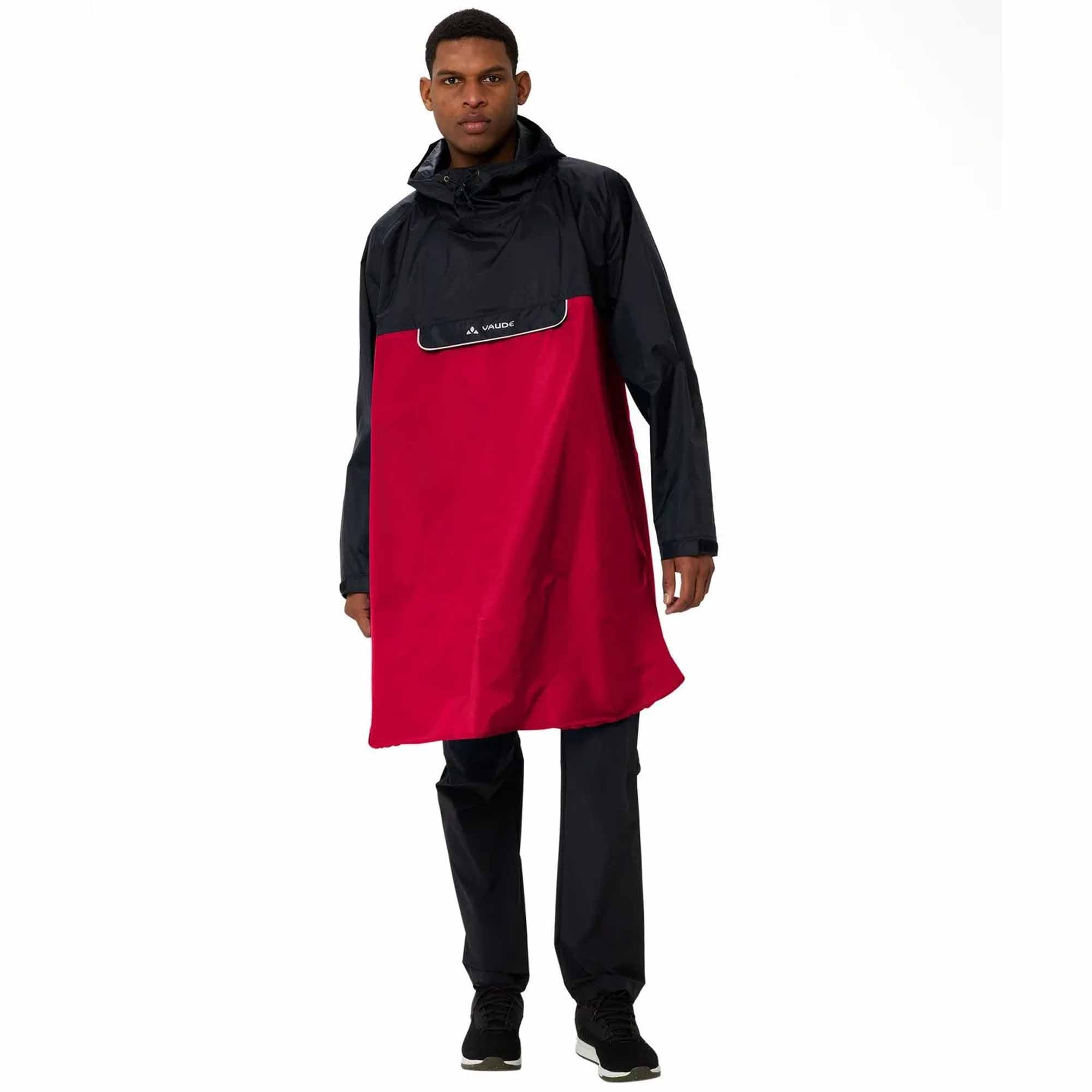 Person wearing a black and red biking rain poncho on a white background