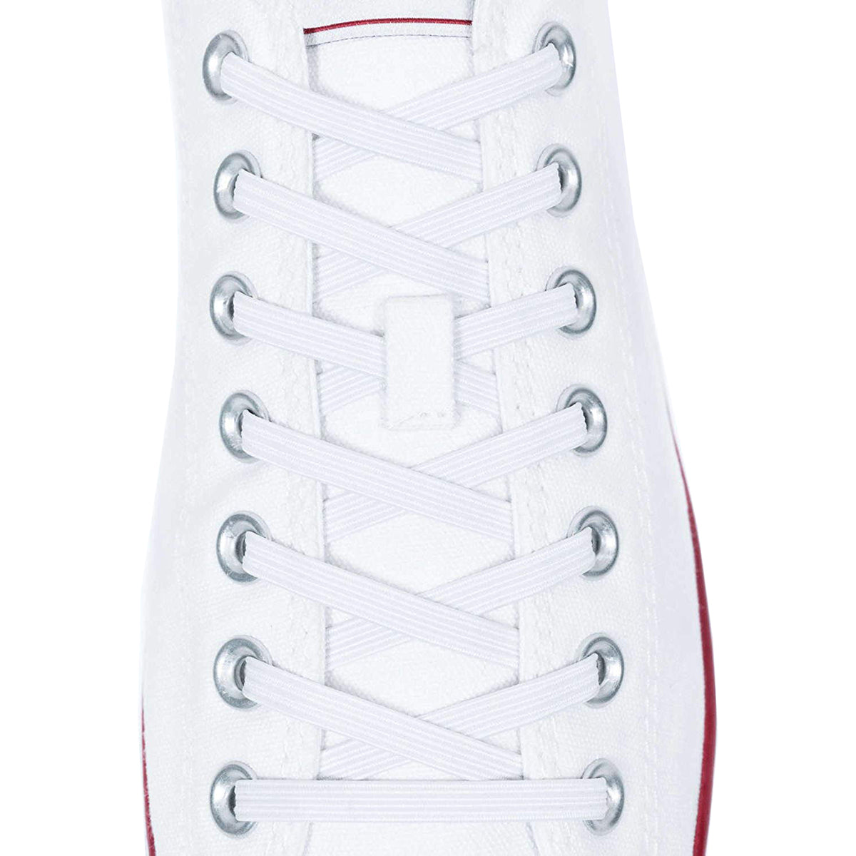 Close-up of white shoelaces on a white sneaker with a red sole.