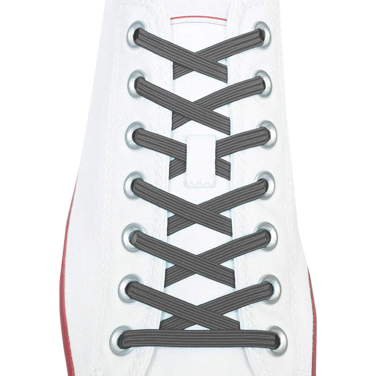 Close-up of a white sneaker with black shoelaces on a white background