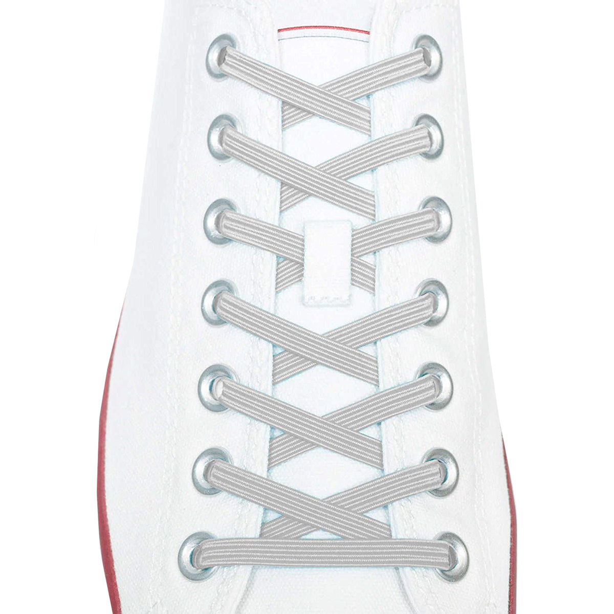 Close-up of a white sneaker with silver metallic shoelaces on a white background