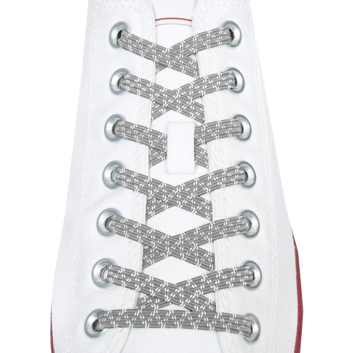 Close-up of a white sneaker with silver metallic shoelaces on a white background