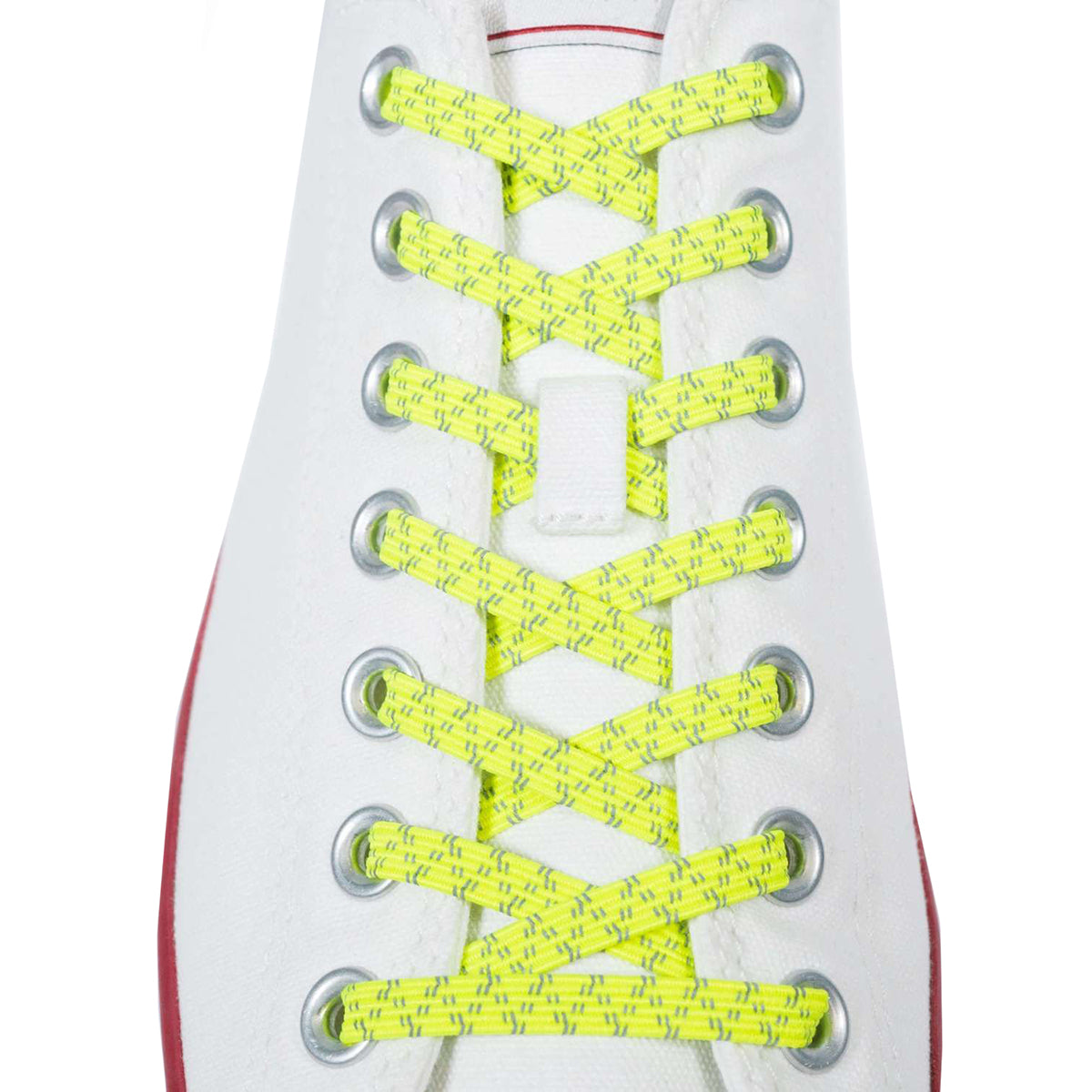Yellow shoelaces on a white sneaker with a red sole.
