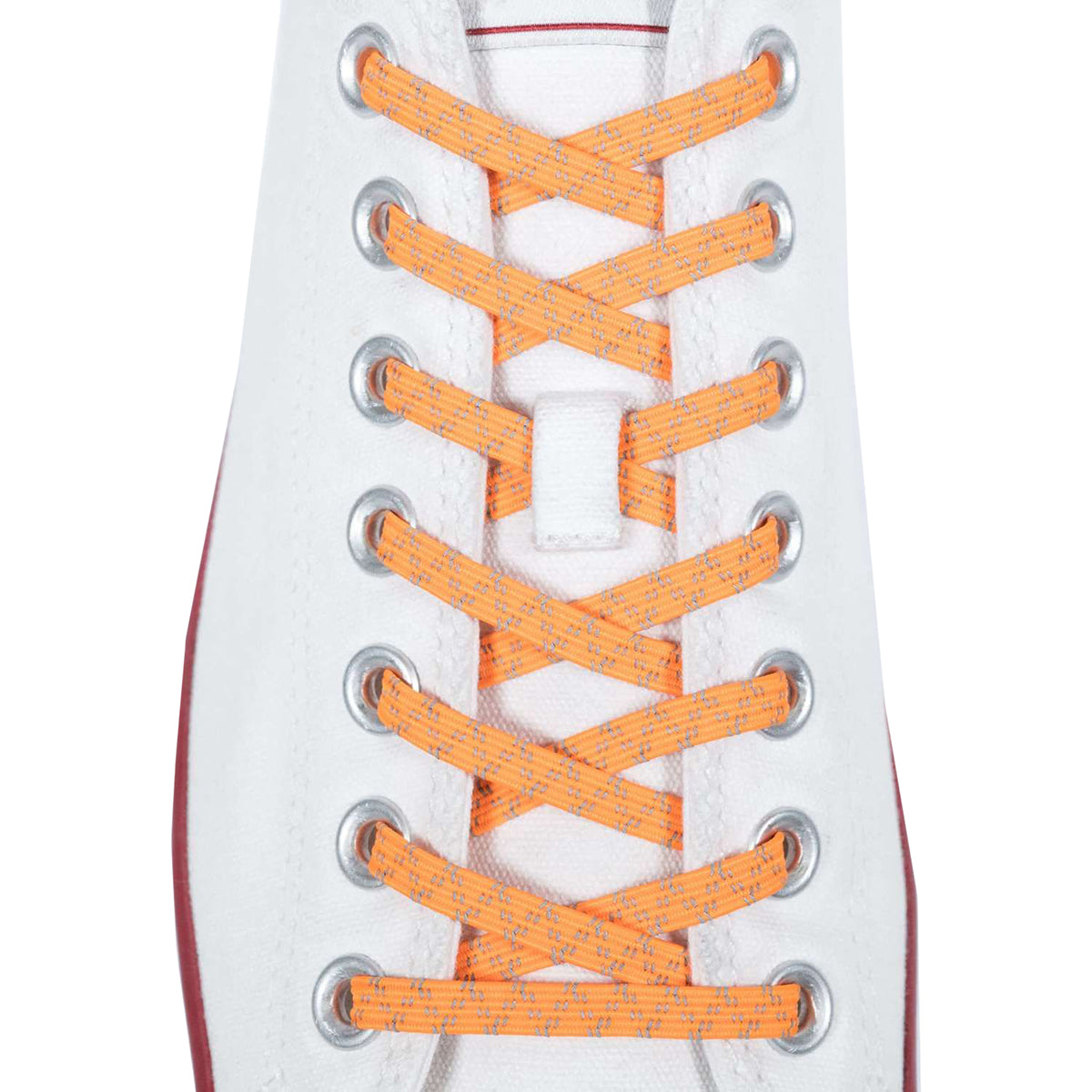Close-up of a white sneaker with orange shoelaces on a white background