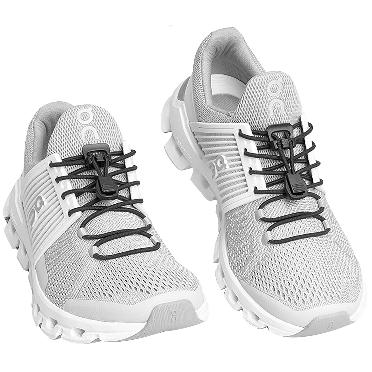 Pair of white running shoes with black laces on a white background